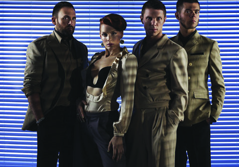 Four people posing in stylish outfits.