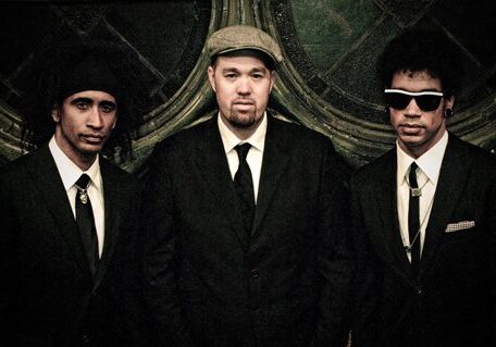 Three men in suits, vintage style portrait.