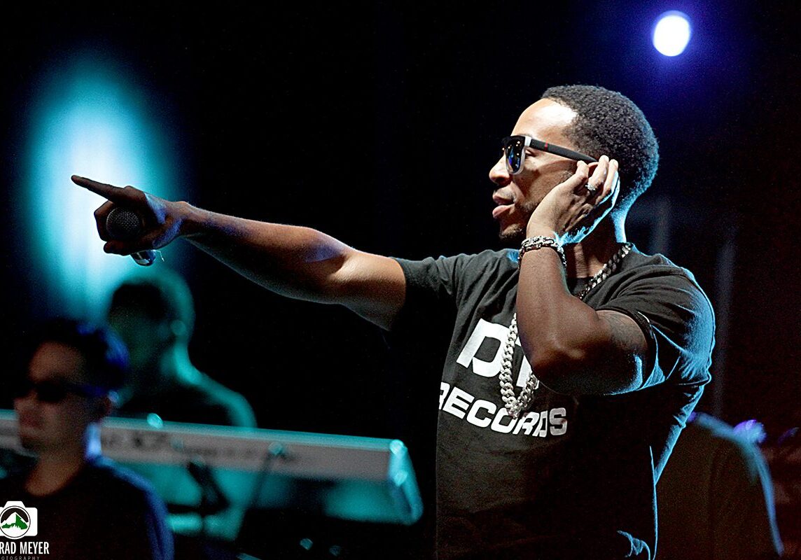 Performer pointing on stage during concert.