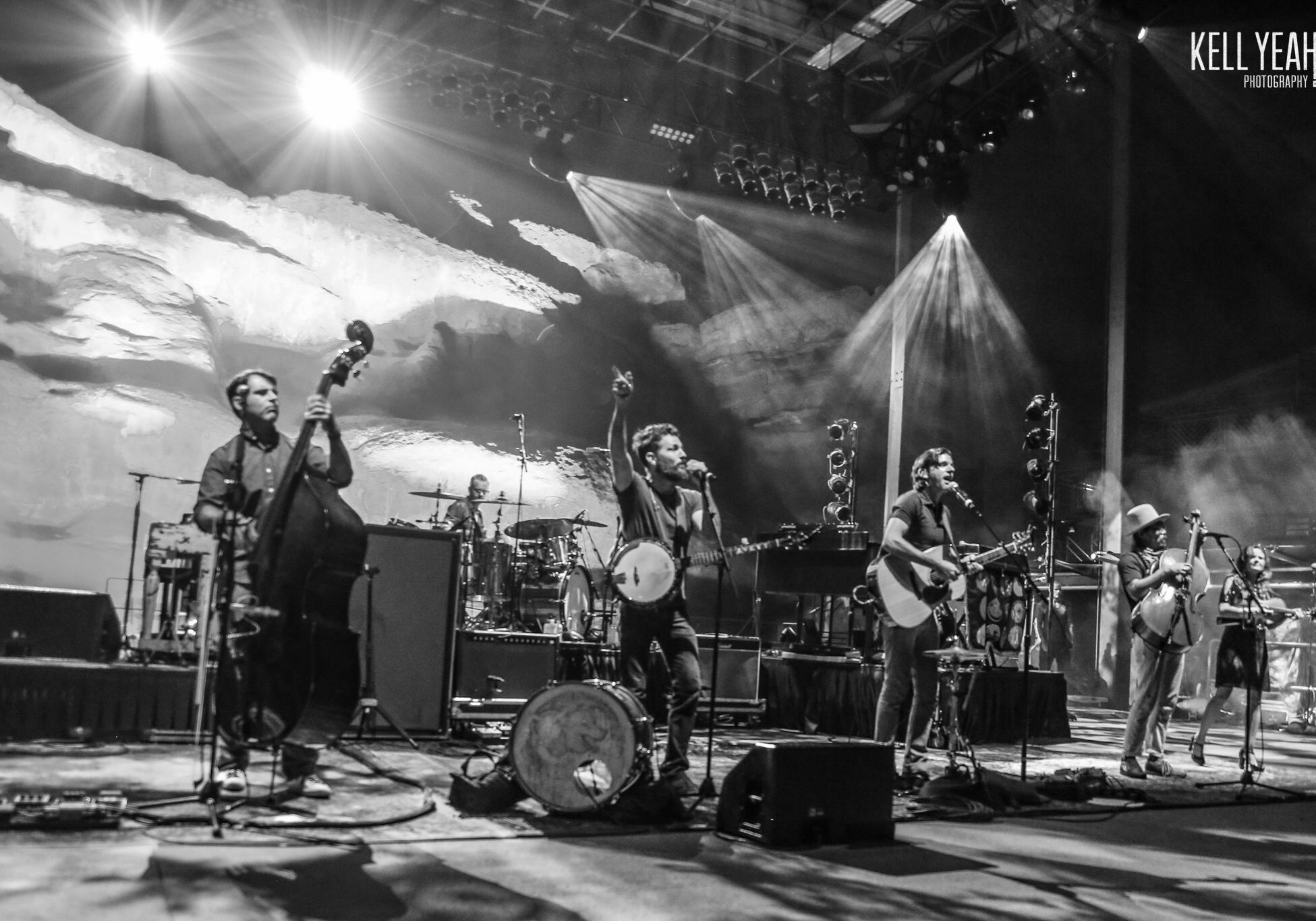 Band performing on stage with instruments.
