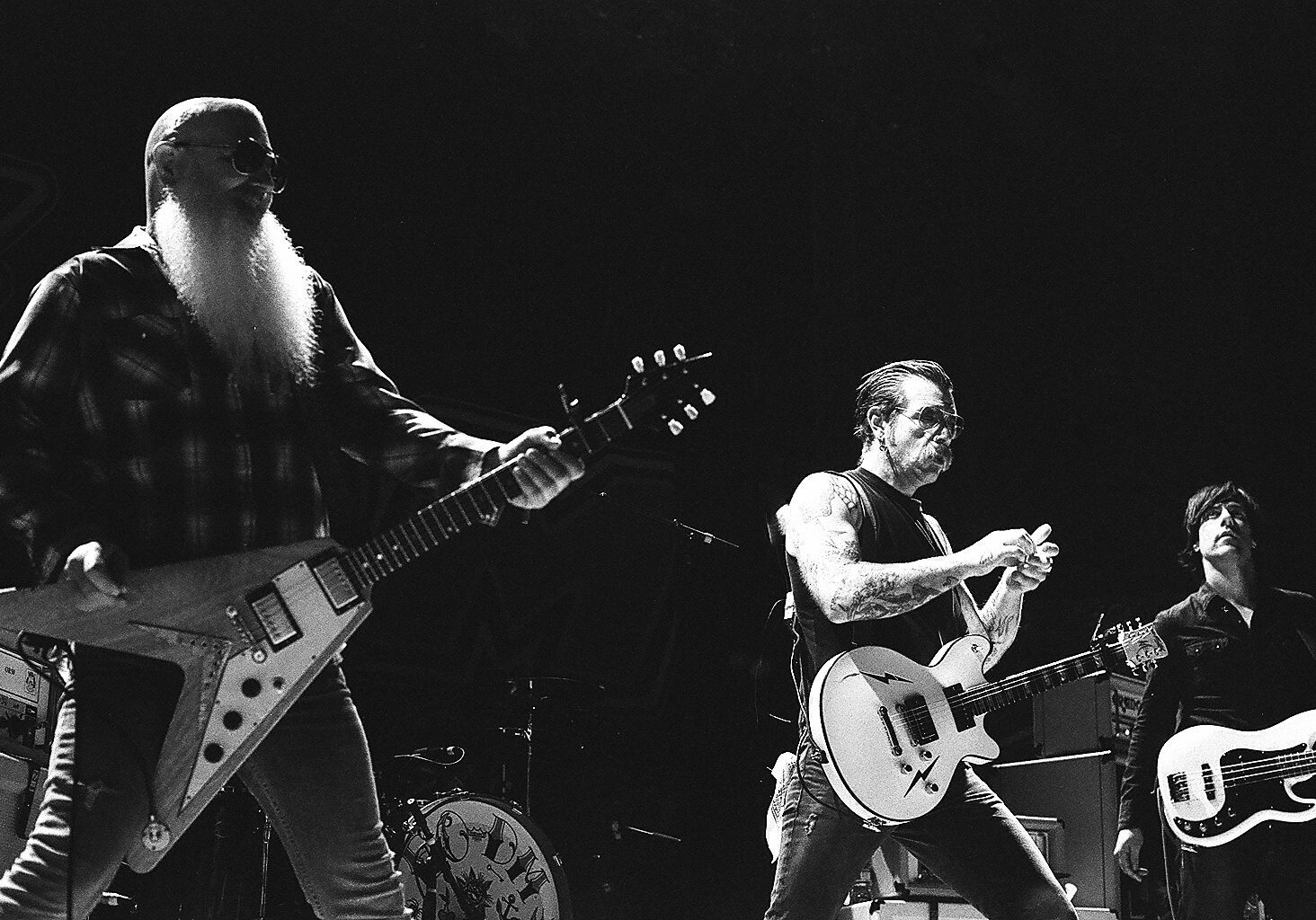 Rock band performing energetically on stage.