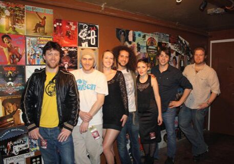 Group of people in front of posters.