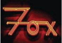 Neon sign spelling "Fox" in orange.