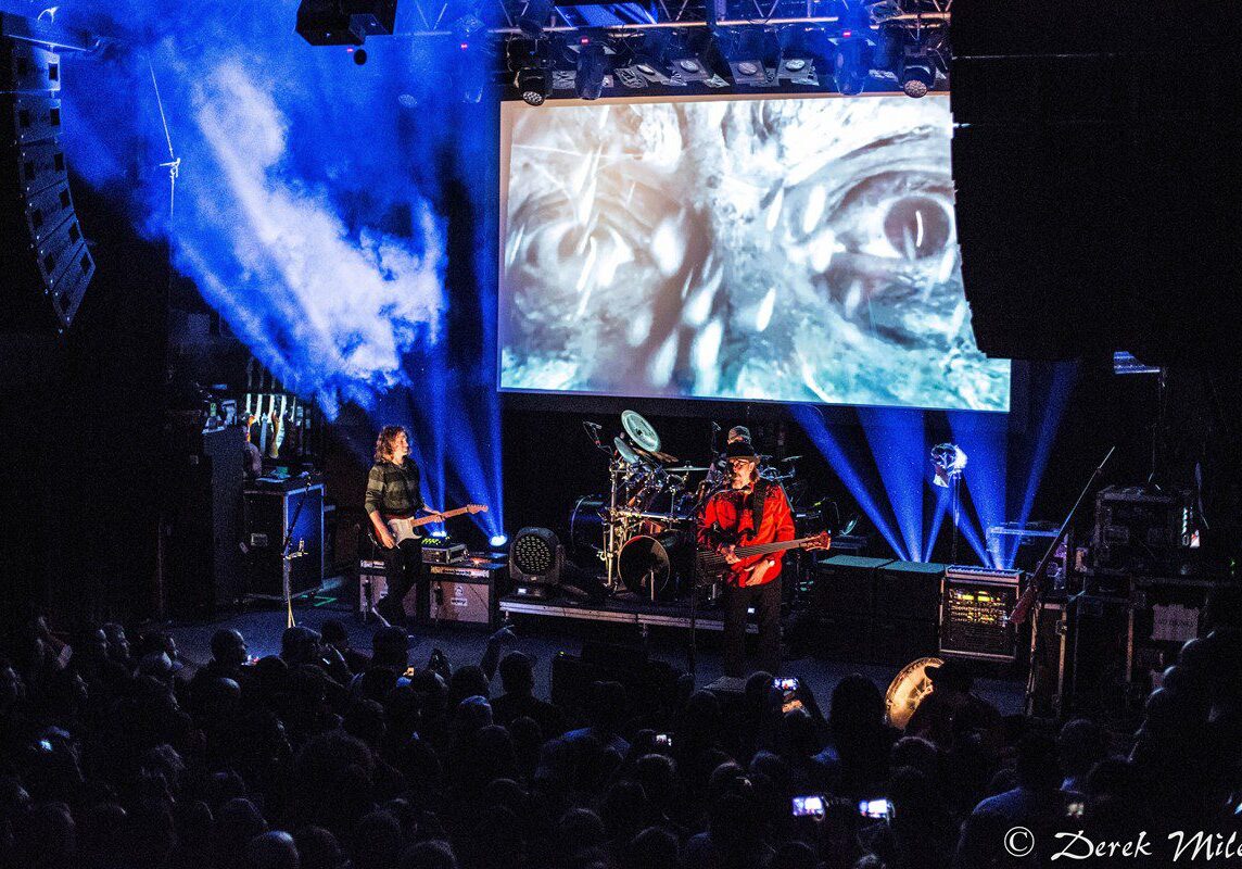Band performing on stage with visual effects.