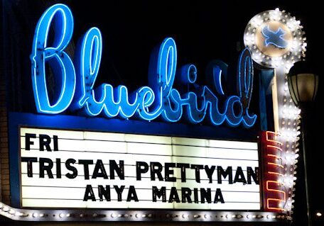 Bluebird Theater marquee with concert names displayed.