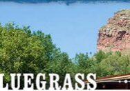 Planet Bluegrass sign with scenic background.