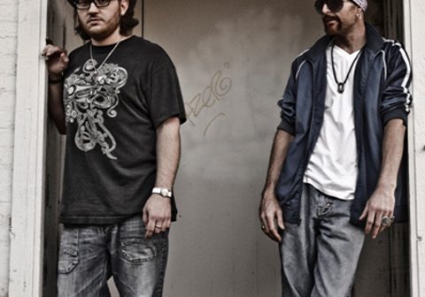 Two men standing in front of doorway.