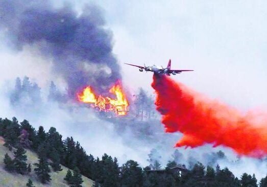 Firefighting plane drops retardant on wildfire.