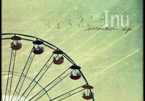 Ferris wheel under a vintage textured sky.