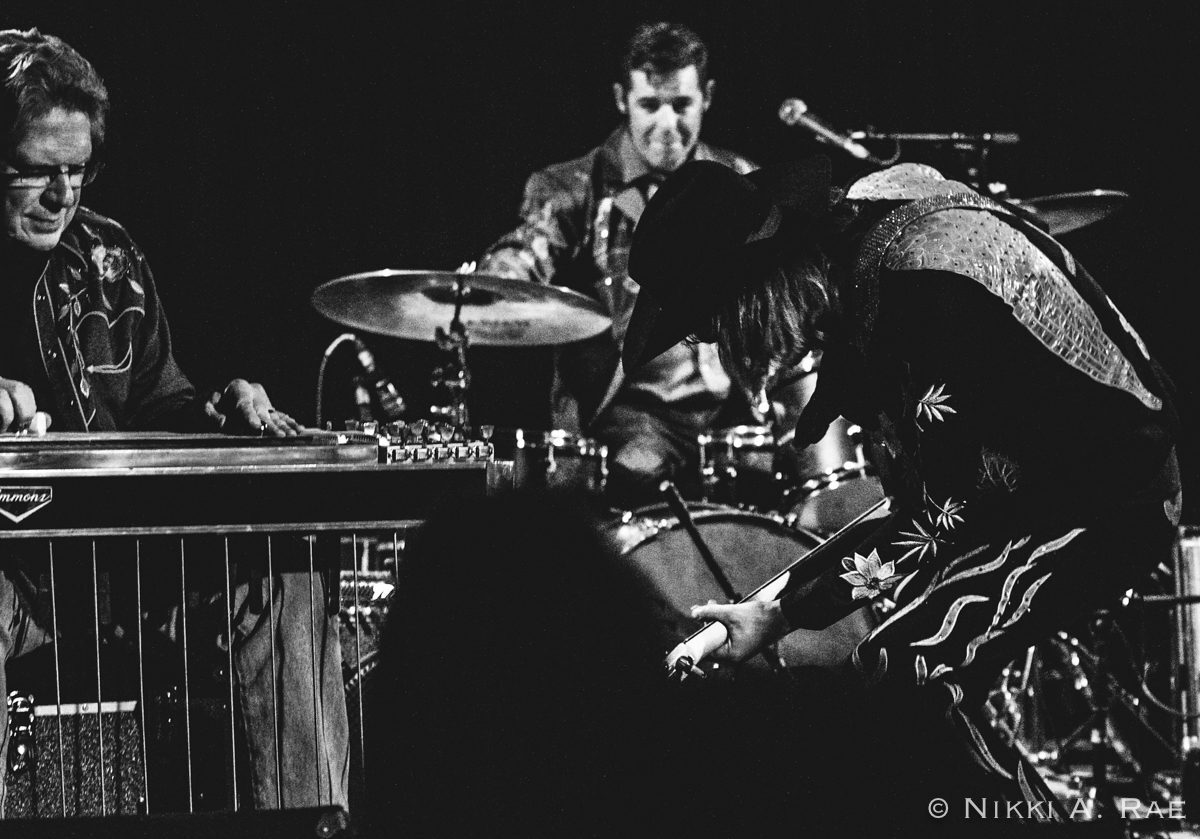 Musicians performing on stage, black and white.