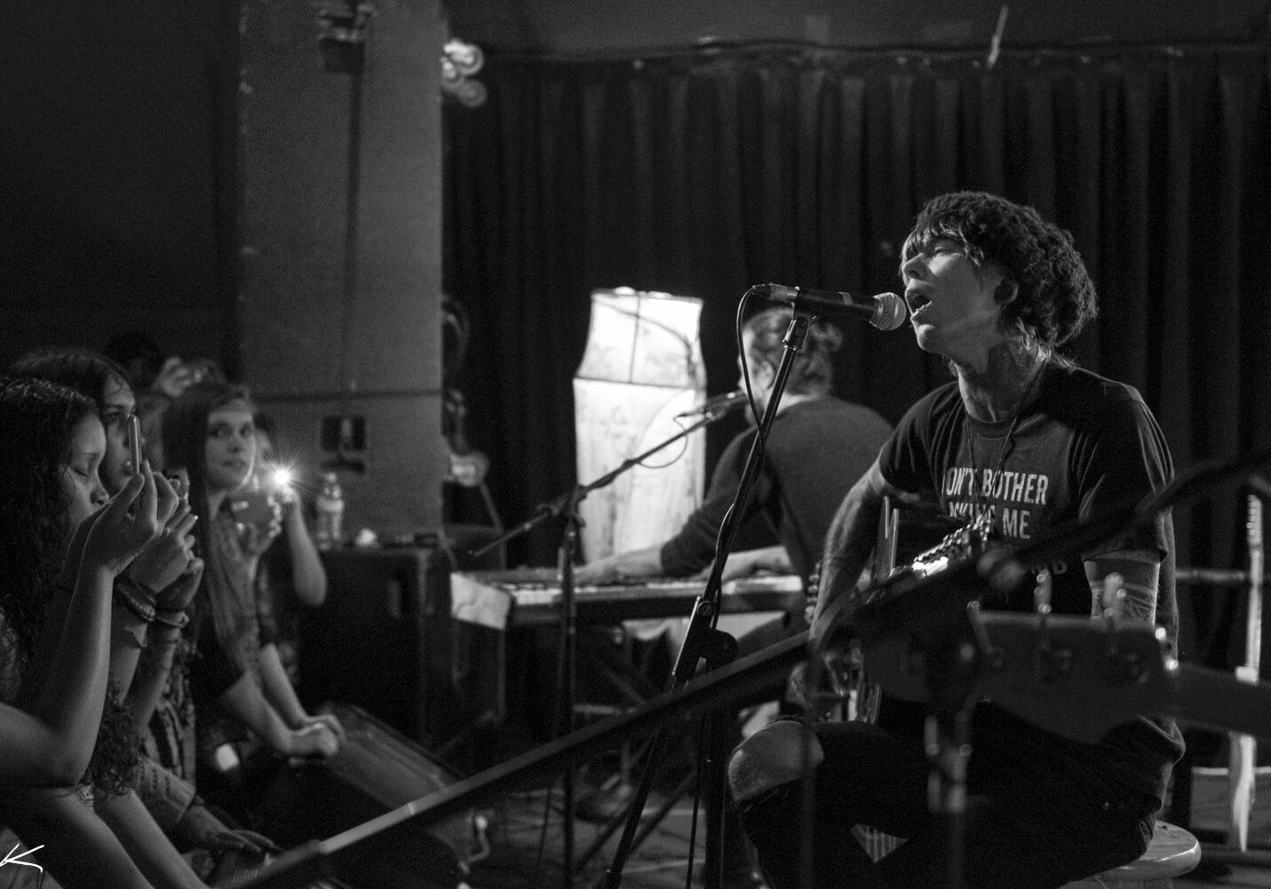 Singer performing live in intimate venue setting.