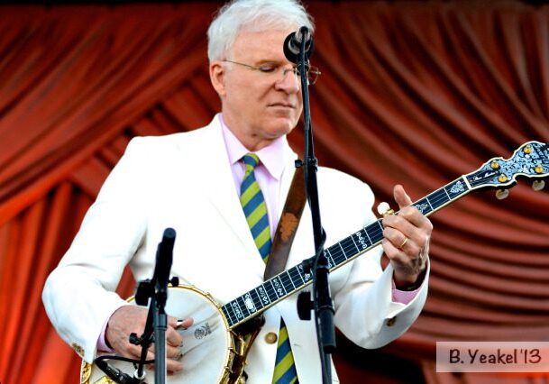 Man playing banjo on stage.