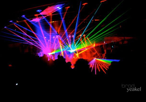 Colorful lasers in a dark concert venue.