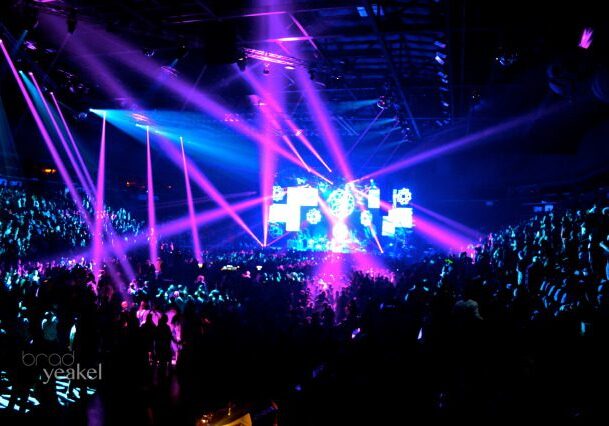 Concert with vibrant pink and blue lights.