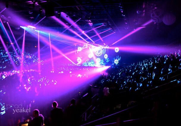 Concert with vibrant stage lights and crowd.