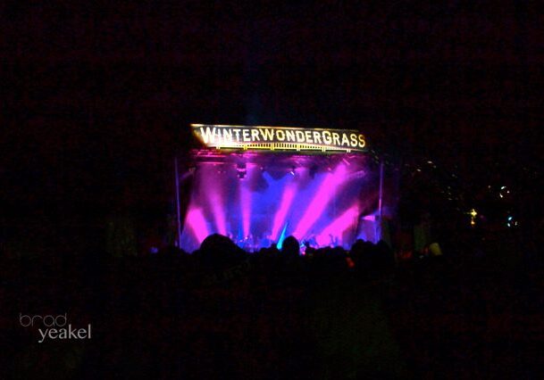 Concert stage with colorful lights at night.