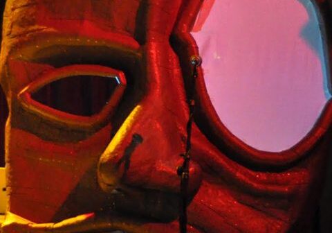 Large, colorful abstract face sculpture with lighting.