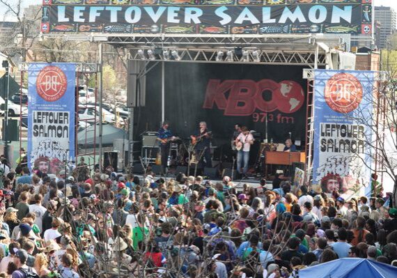 Outdoor concert with band and large crowd.