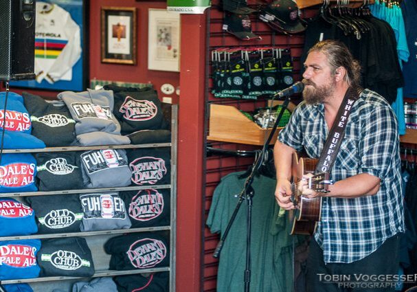 Musician performing in a store with merchandise.