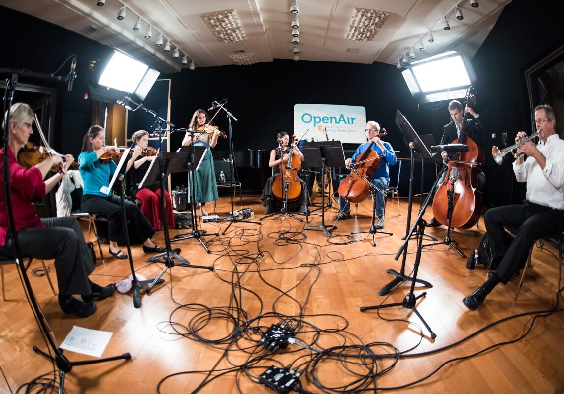 Musicians performing in a recording studio ensemble.