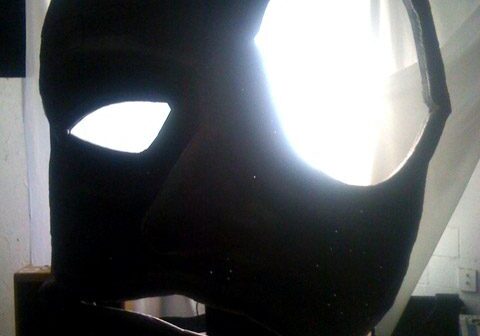 Large abstract mask sculpture with glowing eyes.
