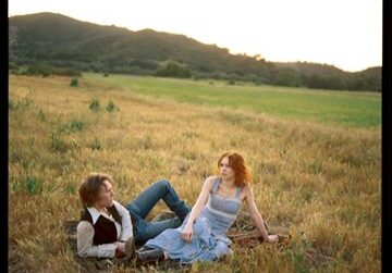Couple relaxing in a sunny field.