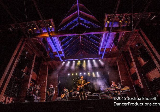 Band performing on an illuminated stage.