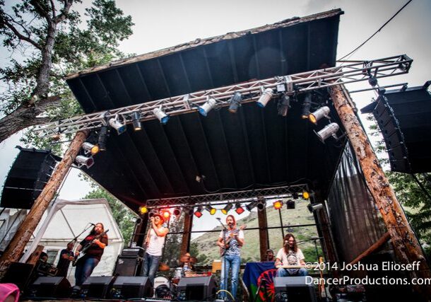 Outdoor concert with band performing on stage.