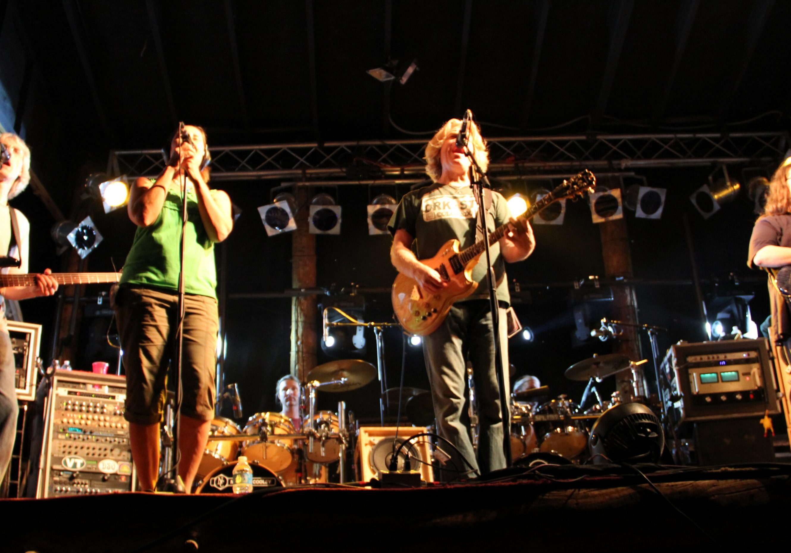 Band performing on stage with instruments.