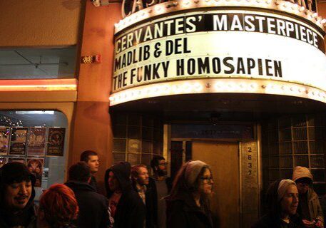 Crowd outside venue with marquee sign.