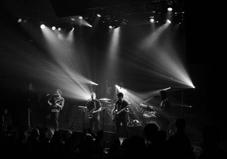 Band performing live on stage, black-and-white.