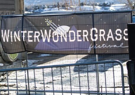 WinterWonderGrass Festival sign with snowy background.