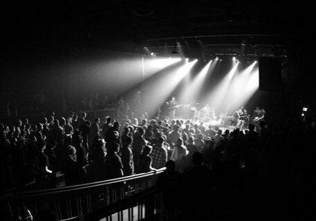 Concert crowd in black and white lighting.