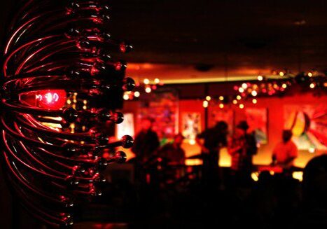 Dimly lit bar with vibrant red lighting.