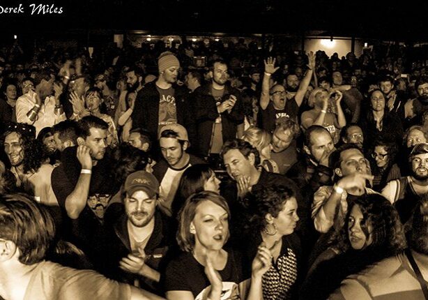 Crowd enjoying a concert in sepia tone.