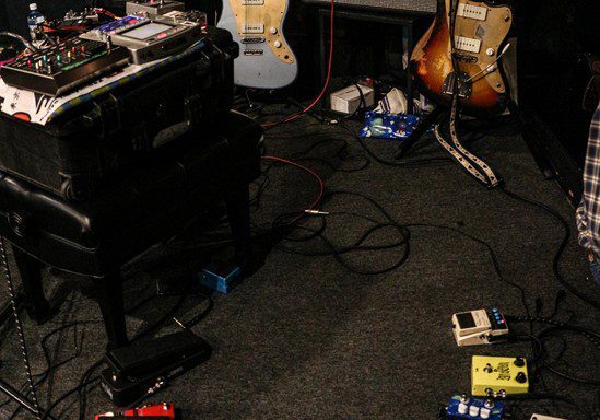 Guitars and effect pedals in music studio.