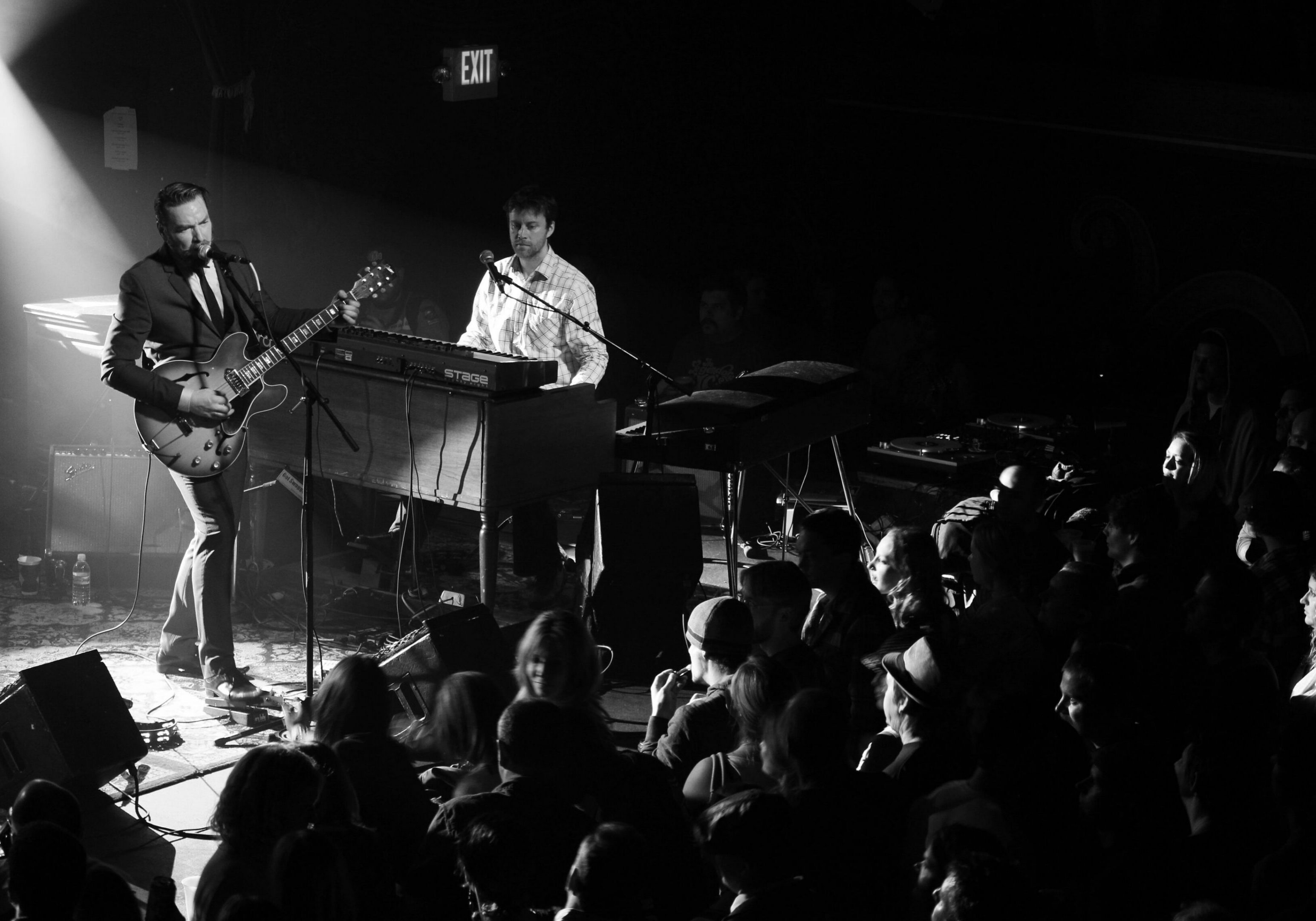 Musicians performing on stage to audience.