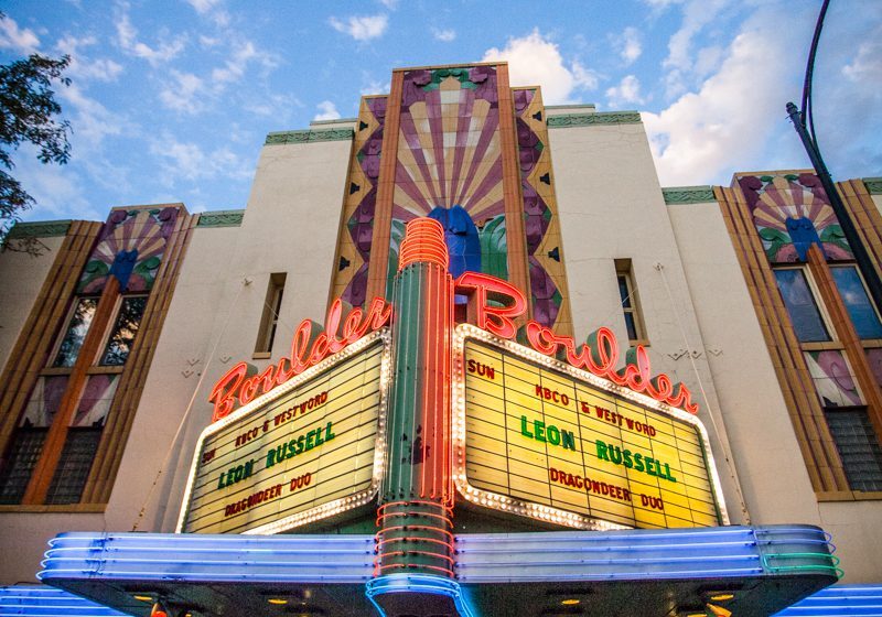 Art deco theater facade with neon lights.