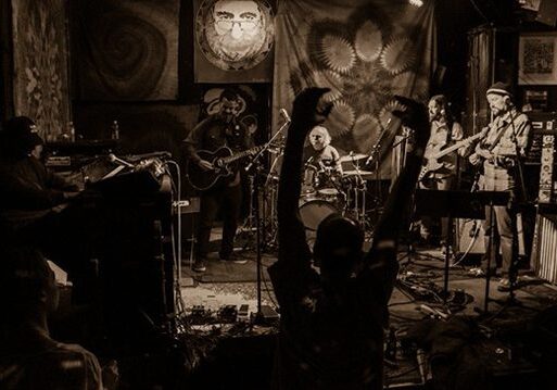 Live band performing on dimly lit stage.