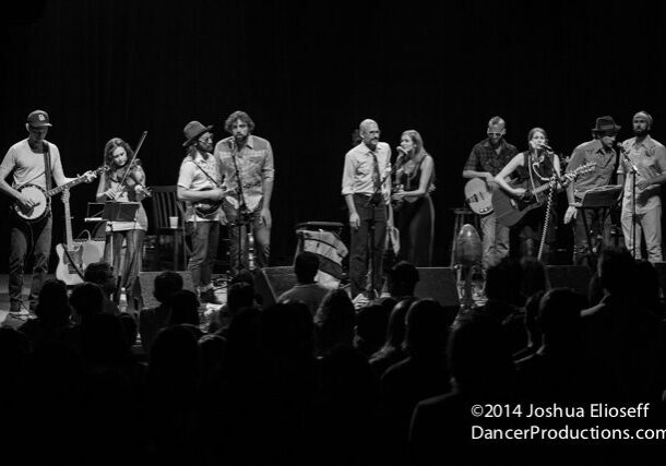 Band performing on stage in black and white.