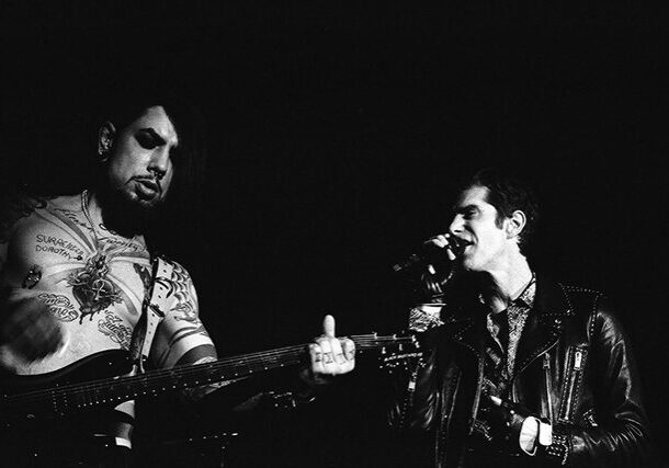 Two musicians performing on stage together.