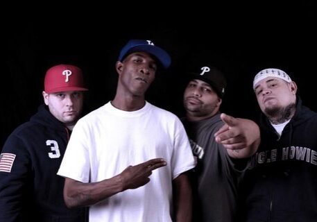 Four men posing in casual streetwear.