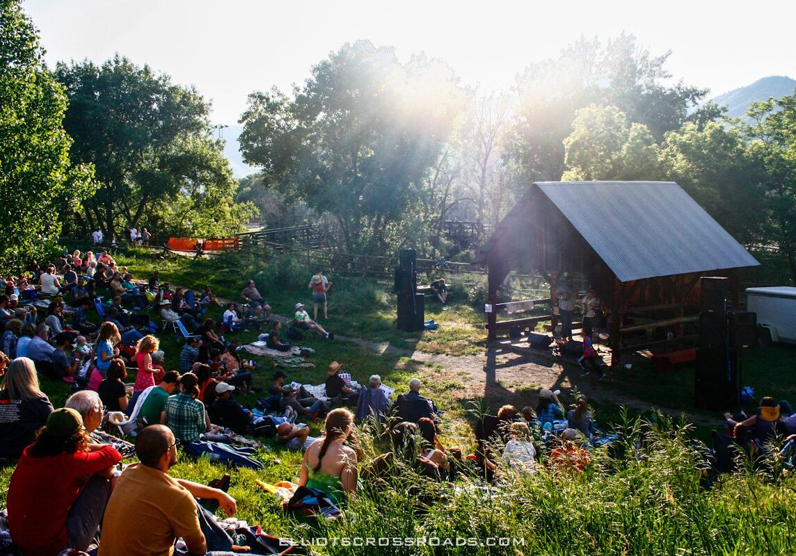 Outdoor concert with audience in a park.