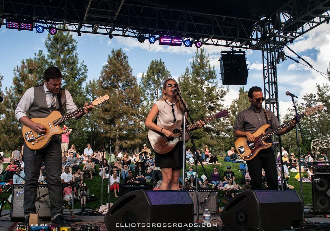 Band performing live on outdoor stage.