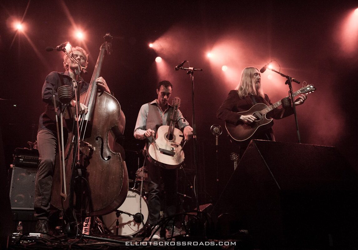 Musicians performing on stage with instruments.