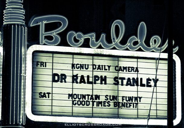 Marquee sign with event listings at night.