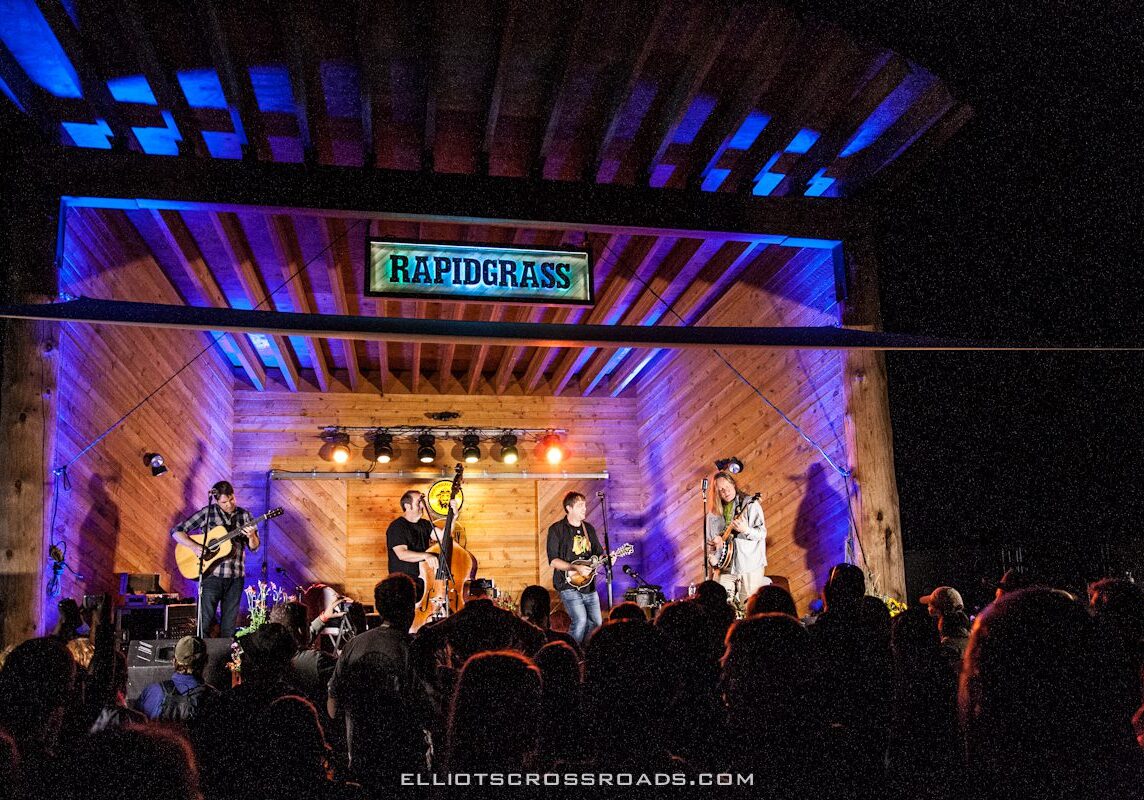 Band performing on stage at night concert.