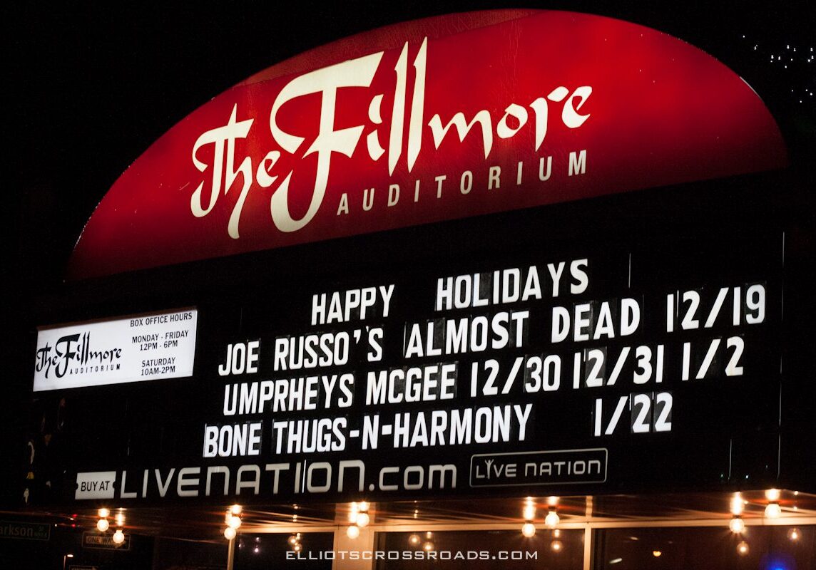 Fillmore Auditorium concert schedule marquee at night.