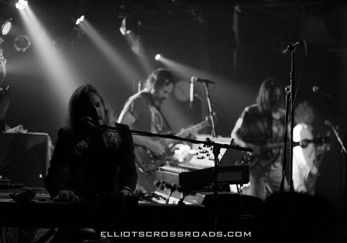 Band performing on stage with instruments.