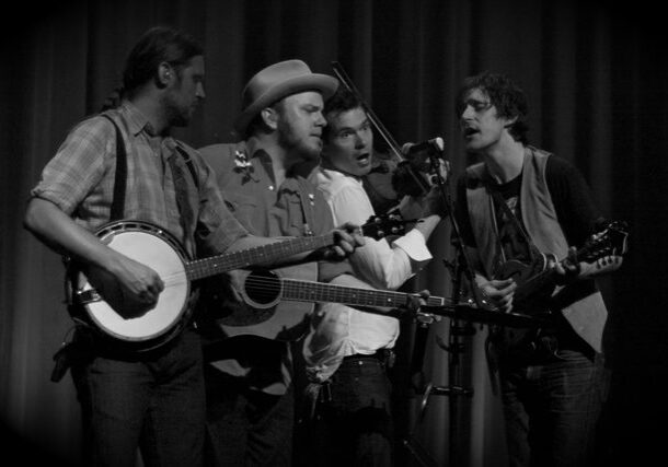 Band performing with banjo, guitar, and violin.